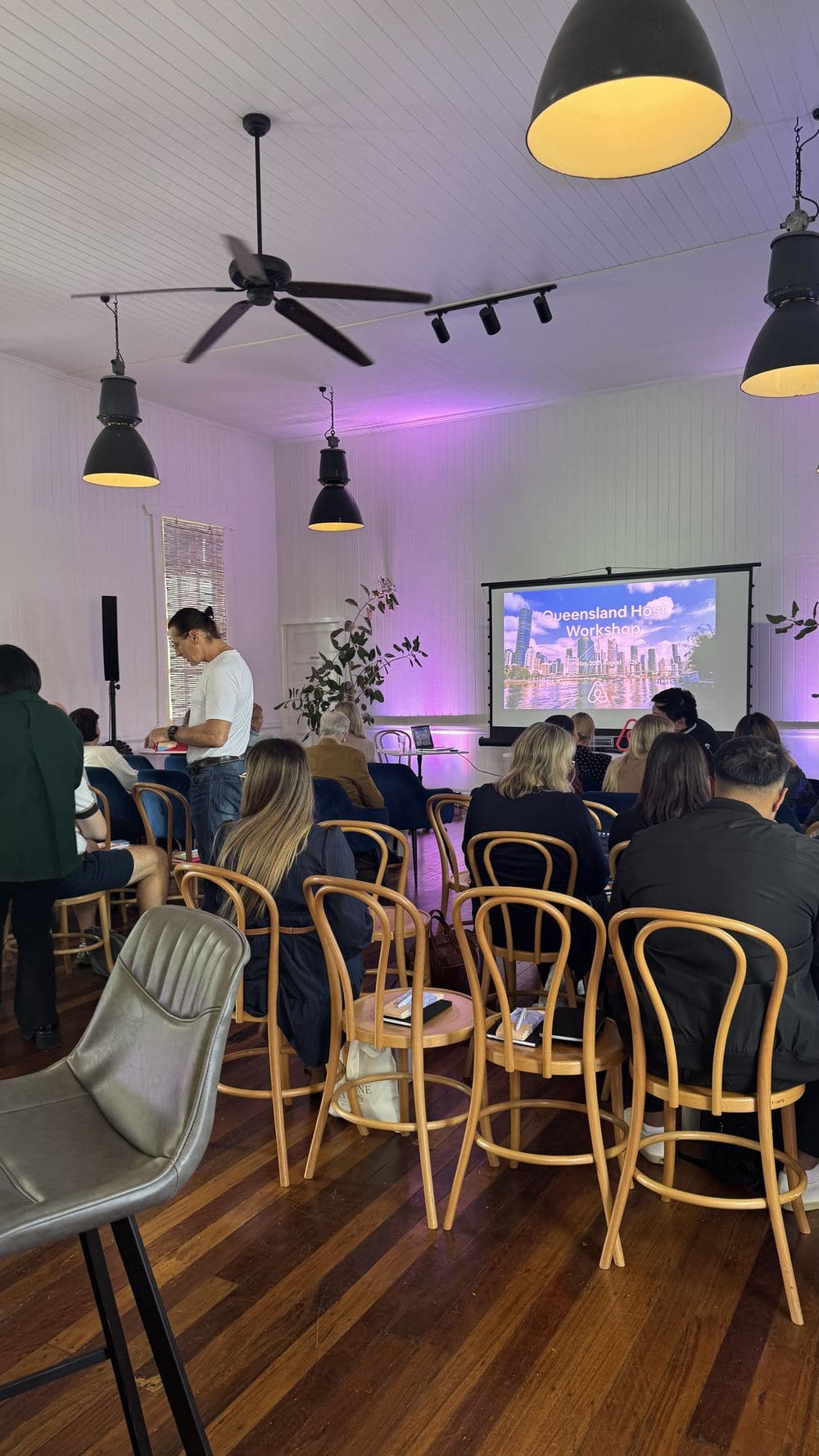 The Airbnb Queensland Host Workshop session in progress with hosts seated facing the presentation