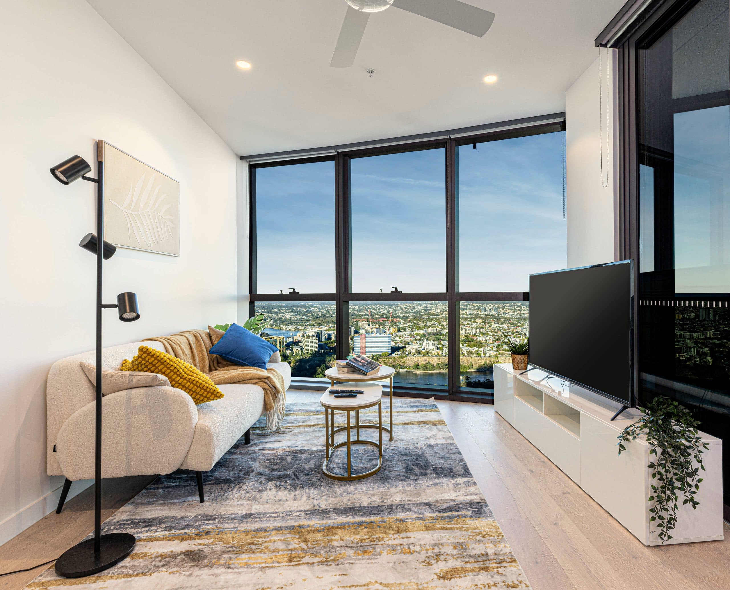 Living room with floor-to-ceiling windows over the Brisbane River